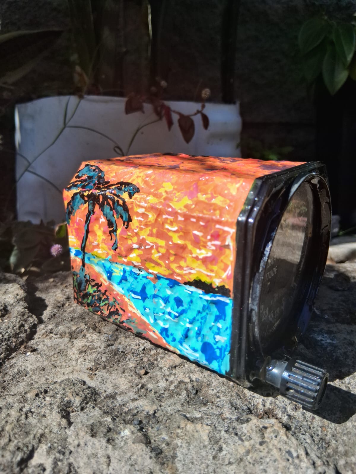 Detail of the painted radar altimeter housing with turquoise sea and orange sky